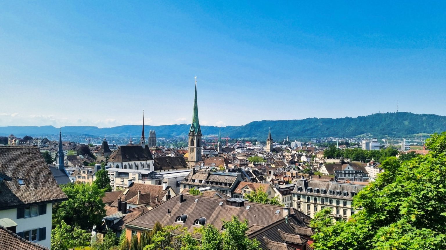 a view of a city with mountains in the background