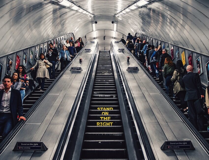 people riding escalator